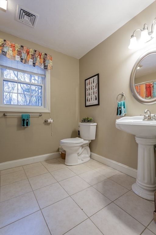 bathroom with tile flooring and toilet