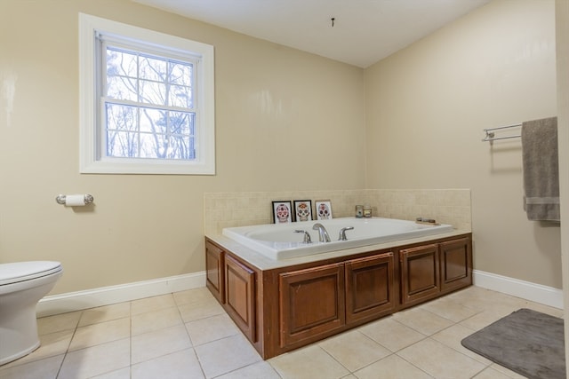 bathroom featuring toilet, tile floors, and a bath to relax in