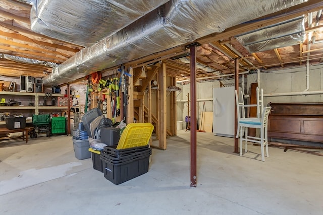 basement featuring white fridge