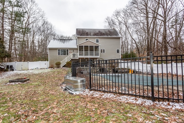 back of property featuring a swimming pool side deck, a sunroom, and a patio area