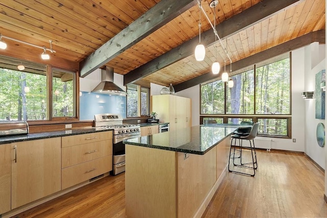 157 Carleton Rd, Carlisle, MA 01741 - kitchen featuring stainless steel gas stove, exhaust hood, light brown cabinets, wood ceiling with exposed beams, and dark stone counters