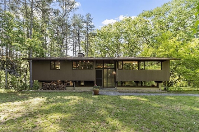 157 Carleton Rd, Carlisle, MA 01741 - view of front of home featuring a front yard and a chimney