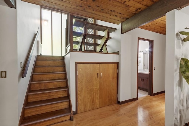157 Carleton Rd, Carlisle, MA 01741 - stairs featuring wood finished floors, wooden ceiling with exposed beams, and baseboards