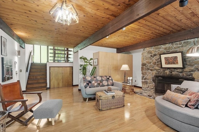 157 Carleton Rd, Carlisle, MA 01741 - living area with stairway, light wood-type flooring, a stone fireplace, and wooden ceiling with exposed beams