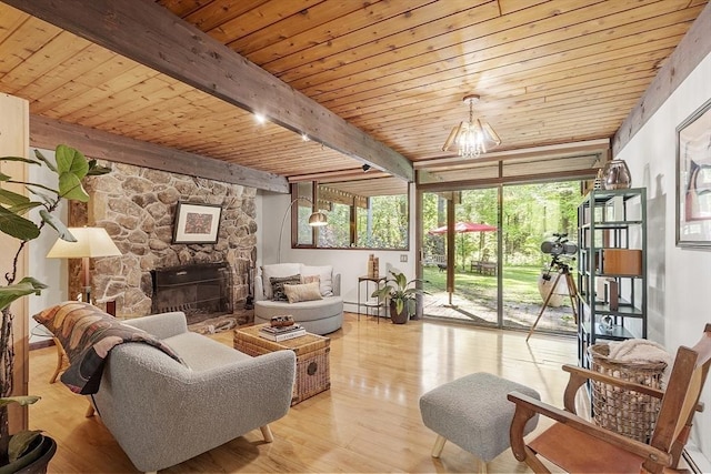 157 Carleton Rd, Carlisle, MA 01741 - living room with wood ceiling with exposed beams, wood finished floors, and a stone fireplace