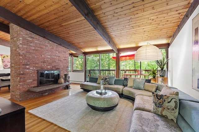 157 Carleton Rd, Carlisle, MA 01741 - living room with wood ceiling, wood finished floors, a fireplace, and a baseboard radiator