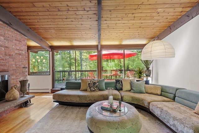 157 Carleton Rd, Carlisle, MA 01741 - living room with a baseboard radiator, wood finished floors, wooden ceiling, floor to ceiling windows, and a brick fireplace