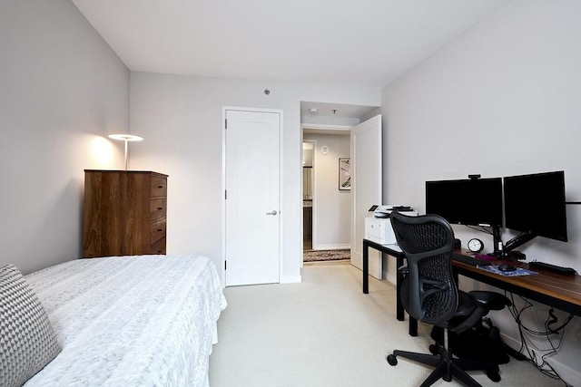 580 Washington St Unit 10A, Boston, MA 02111 - bedroom with light carpet, a desk, and baseboards