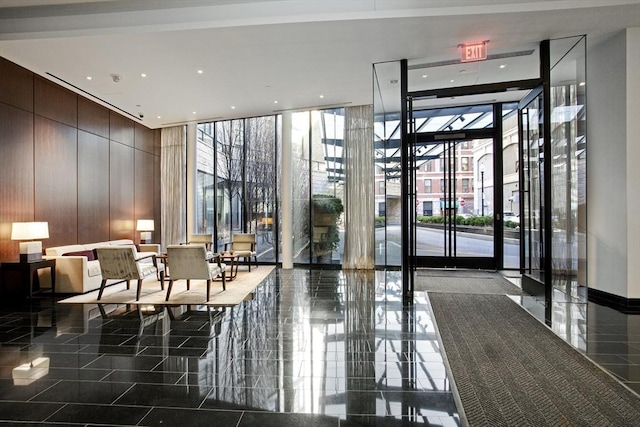 580 Washington St Unit 10A, Boston, MA 02111 - building lobby with a wall of windows, a towering ceiling, recessed lighting, and wooden walls