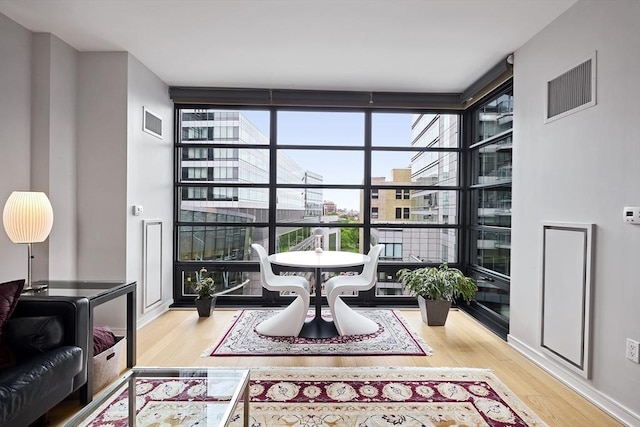 580 Washington St Unit 10A, Boston, MA 02111 - living area with a wall of windows and wood finished floors