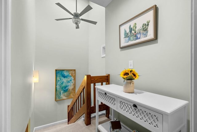 interior space featuring light colored carpet and ceiling fan