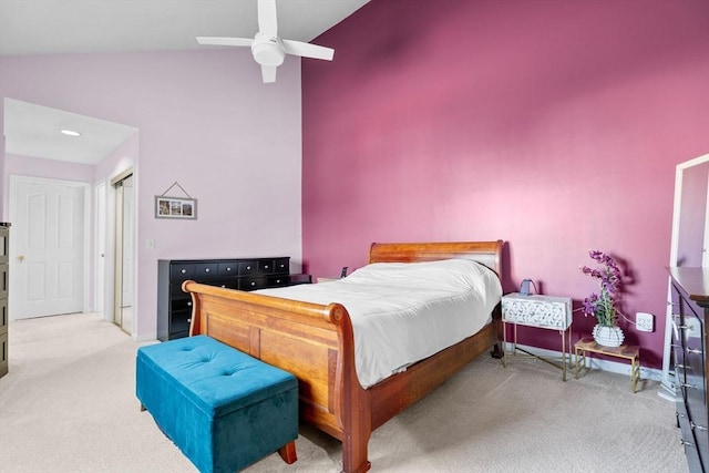 bedroom featuring light carpet, vaulted ceiling, and ceiling fan