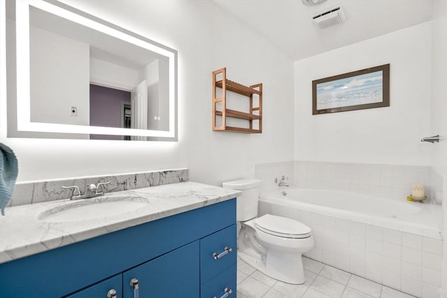 bathroom with tile patterned floors, tiled bath, vanity, and toilet