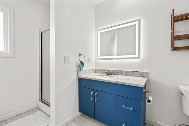 bathroom with tile patterned floors, toilet, vanity, and walk in shower