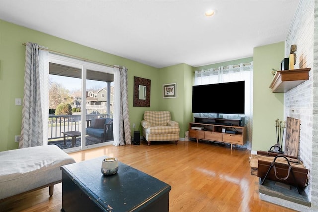 living room with wood-type flooring and plenty of natural light