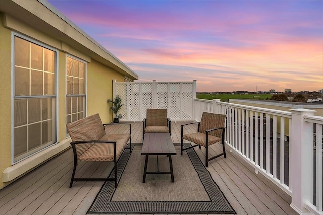 deck at dusk with outdoor lounge area