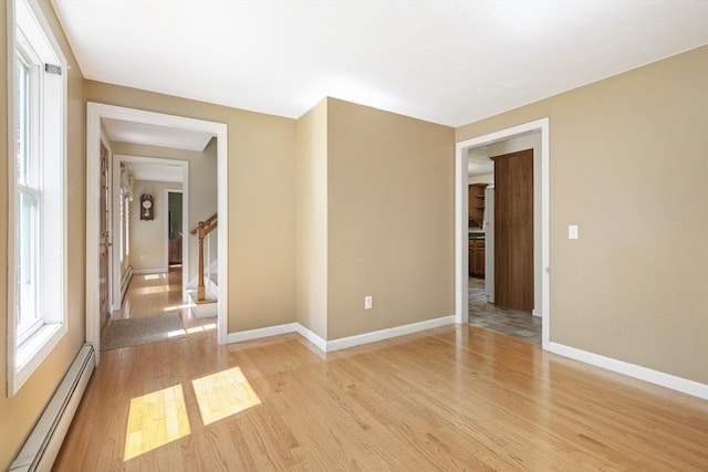 232 Wallum Lake Rd, Douglas, MA 01516 - empty room featuring a baseboard heating unit, light wood-type flooring, and stairs