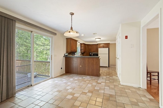 232 Wallum Lake Rd, Douglas, MA 01516 - kitchen featuring freestanding refrigerator, a peninsula, hanging light fixtures, brown cabinets, and recessed lighting