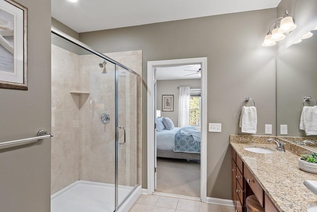 bathroom featuring vanity, a shower with door, and tile patterned floors