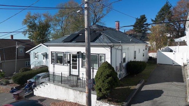 bungalow-style home with solar panels