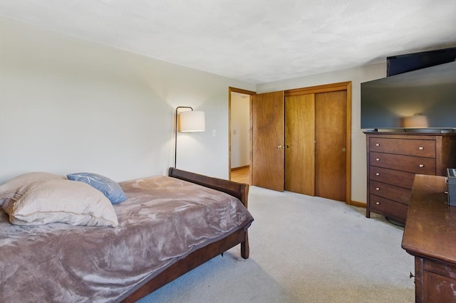 bedroom with light colored carpet and a closet