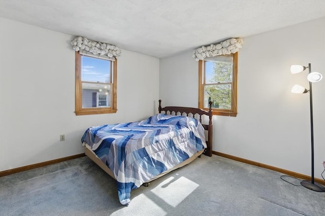 bedroom featuring baseboards and carpet floors