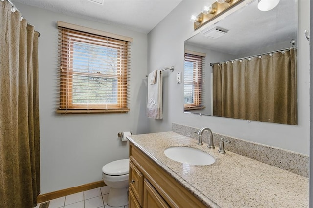 bathroom with vanity, toilet, visible vents, baseboards, and tile patterned flooring