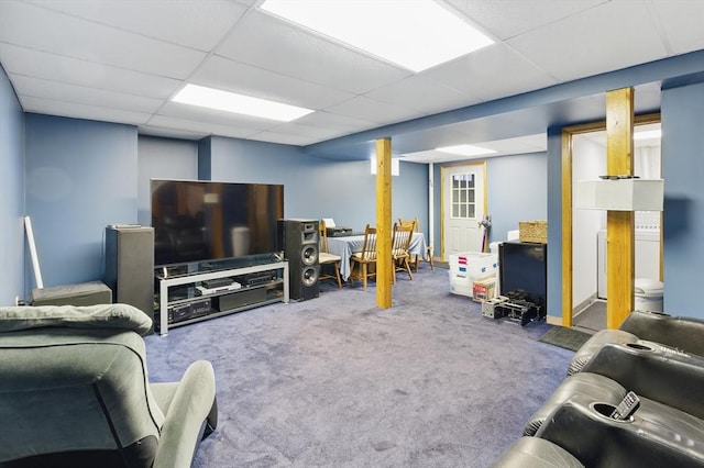 living area with a paneled ceiling and carpet flooring