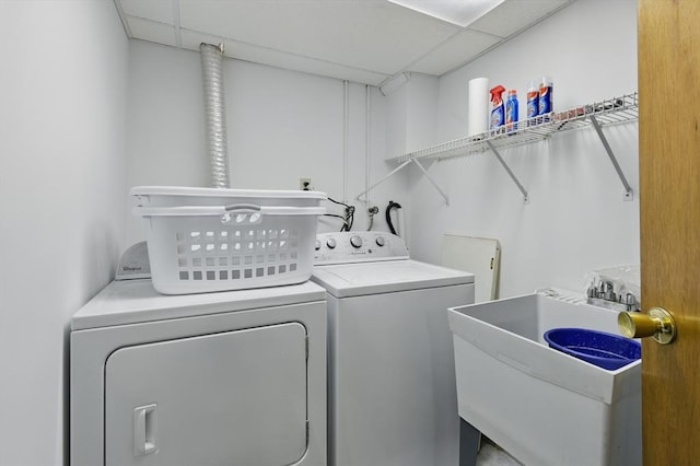 washroom featuring separate washer and dryer, a sink, and laundry area