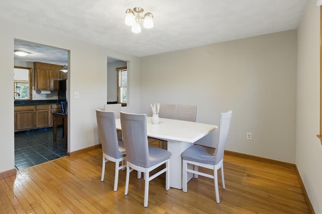 dining space with dark wood-style floors and baseboards