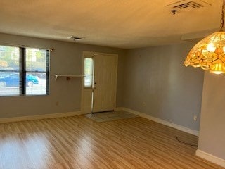 unfurnished room with hardwood / wood-style floors