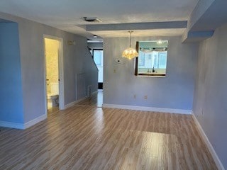 empty room with hardwood / wood-style floors