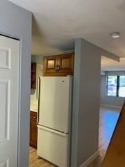 kitchen with white fridge and light hardwood / wood-style floors