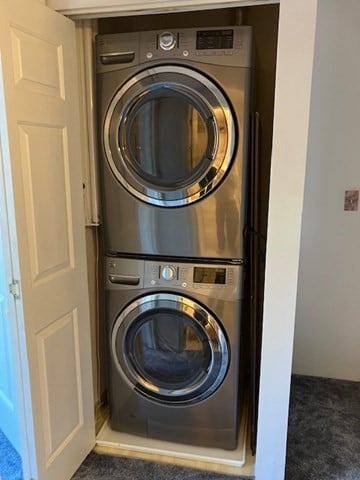 washroom with stacked washer and clothes dryer