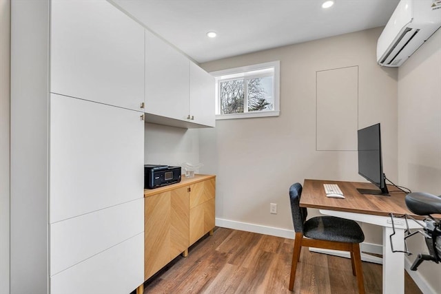 home office featuring an AC wall unit, recessed lighting, wood finished floors, and baseboards