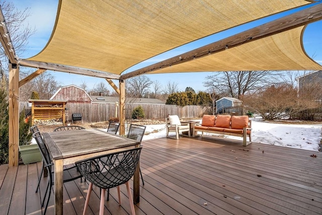 wooden terrace featuring outdoor dining area and a fenced backyard