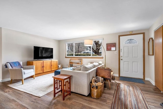 living room featuring baseboards and wood finished floors