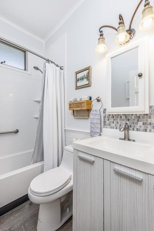 65 Water St Unit 2, Danvers, MA 01923 - full bath featuring crown molding, vanity, shower / bathtub combination with curtain, and wood finished floors