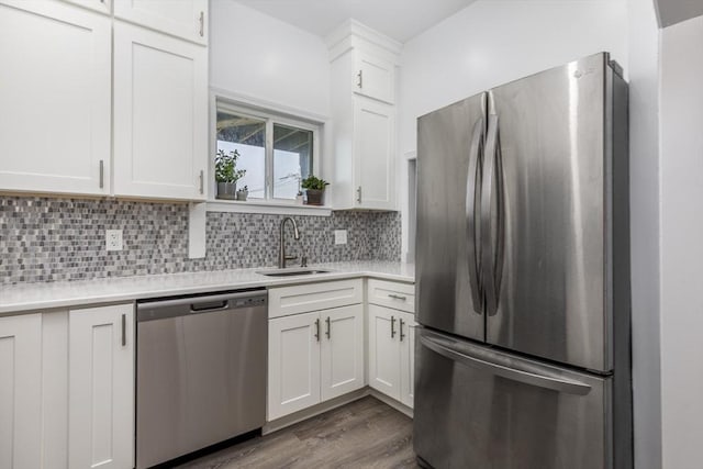 65 Water St Unit 2, Danvers, MA 01923 - kitchen with stainless steel appliances, light countertops, white cabinetry, dark wood-style flooring, and tasteful backsplash