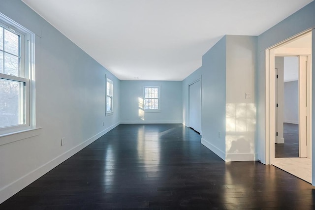 spare room with dark wood-type flooring