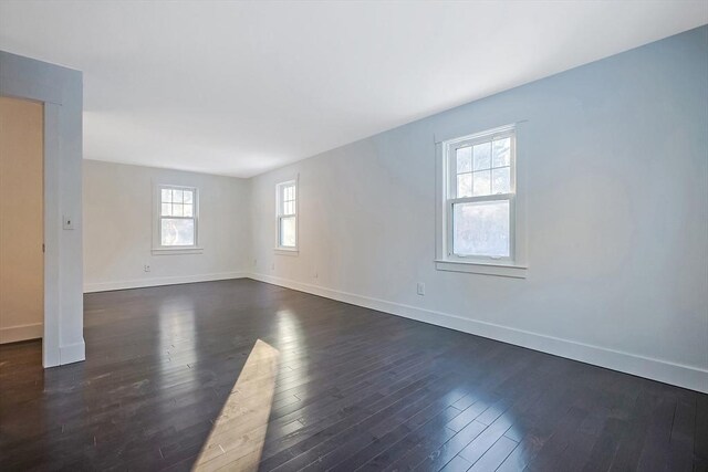 spare room with dark hardwood / wood-style floors