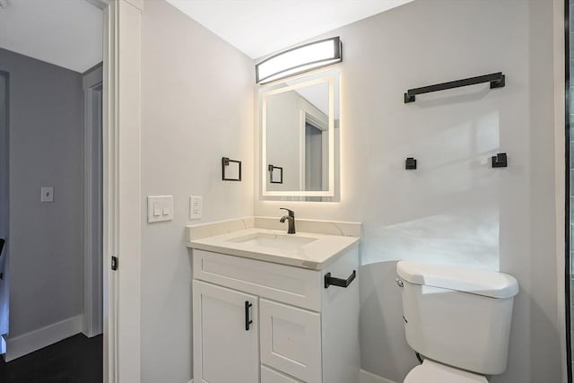 bathroom with vanity and toilet