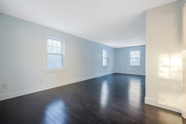 spare room with dark hardwood / wood-style flooring