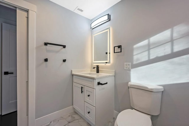 bathroom with vanity and toilet