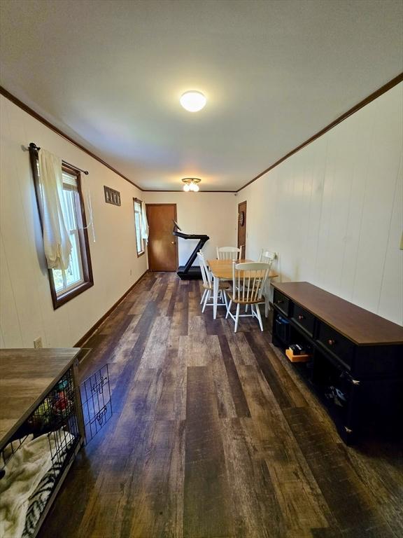 dining room featuring wood finished floors and ornamental molding