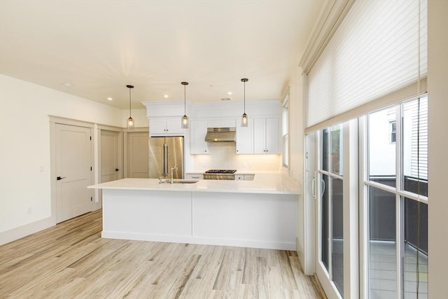 2-6 Market St Unit 2, Newburyport, MA 01950 - kitchen with appliances with stainless steel finishes, exhaust hood, light wood-type flooring, white cabinets, and recessed lighting