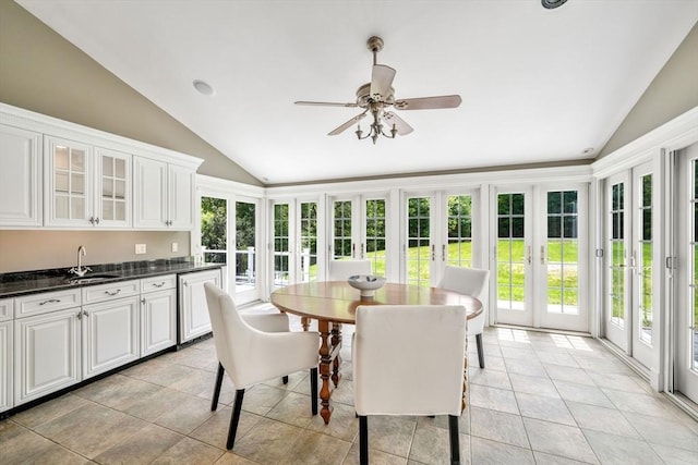 sunroom / solarium with french doors, vaulted ceiling, a sink, and tile patterned floors