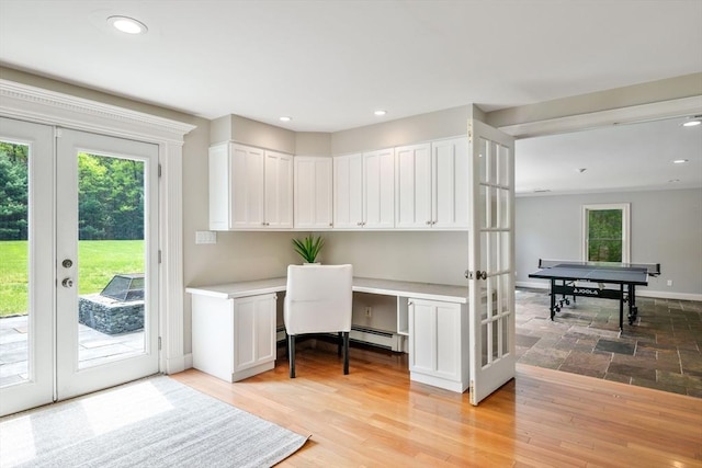 office space featuring built in study area, plenty of natural light, a baseboard heating unit, french doors, and recessed lighting