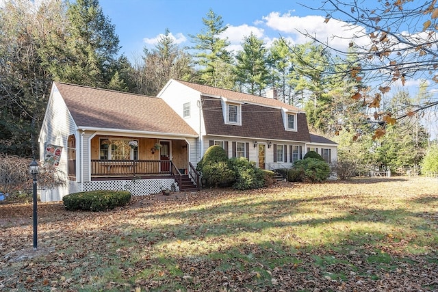 view of front of house with a porch and a front lawn