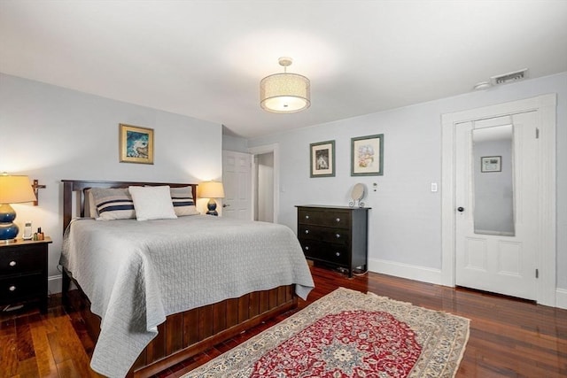 bedroom with visible vents, baseboards, and dark wood-style flooring